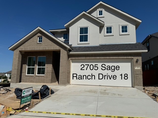 2705 Sage Ranch Dr Unit 18, Leander, TX 78641 - view of front of house with brick siding, concrete driveway, and a garage