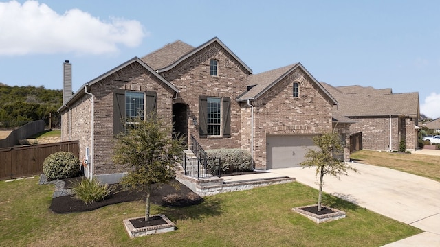 view of front of house featuring a front lawn and a garage