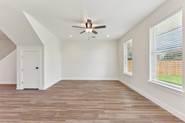 interior space featuring a ceiling fan, light wood-style flooring, baseboards, visible vents, and recessed lighting
