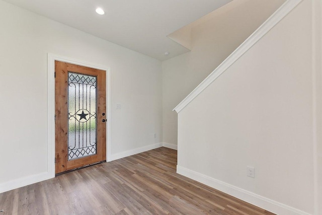 entryway with recessed lighting, wood finished floors, and baseboards