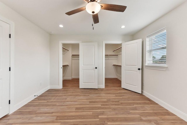 unfurnished bedroom featuring recessed lighting, a closet, a spacious closet, and baseboards