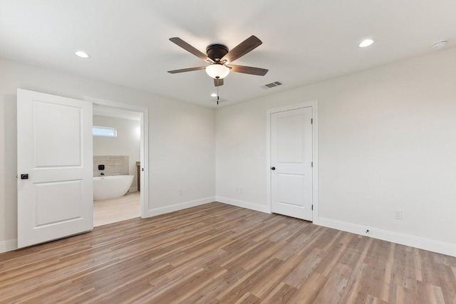 spare room with light wood-type flooring, baseboards, visible vents, recessed lighting, and ceiling fan