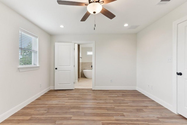 unfurnished bedroom featuring baseboards, ensuite bath, visible vents, and recessed lighting