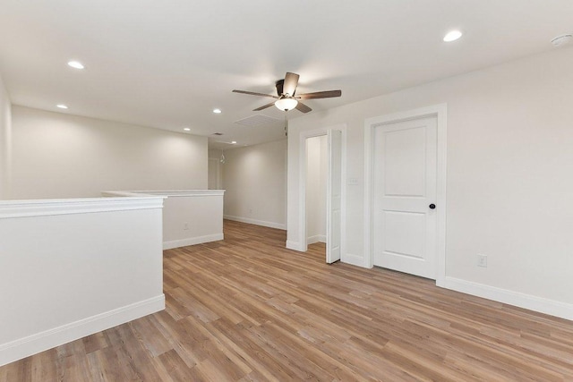 spare room featuring baseboards, recessed lighting, light wood-style floors, and ceiling fan