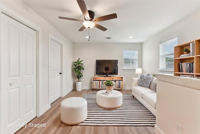 living room featuring baseboards, visible vents, recessed lighting, a ceiling fan, and wood finished floors