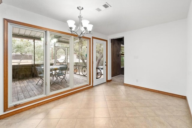 unfurnished dining area with a notable chandelier and light tile patterned floors