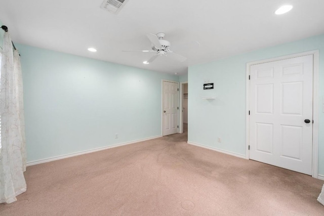 spare room with light carpet and ceiling fan