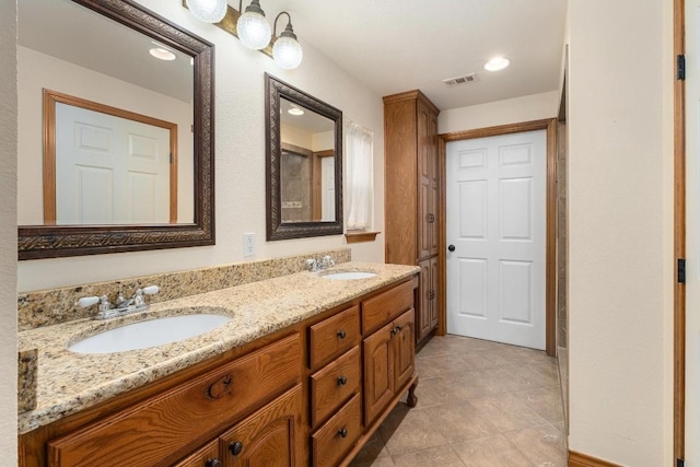 bathroom featuring tile patterned flooring and vanity