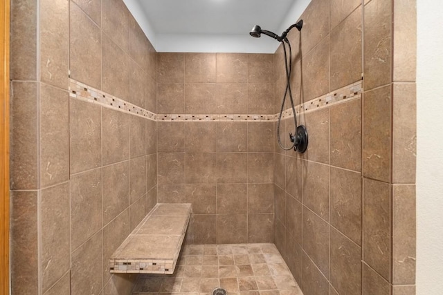 bathroom with a tile shower