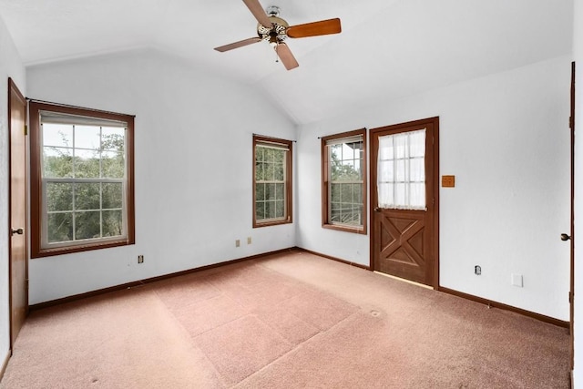 carpeted empty room with lofted ceiling and ceiling fan