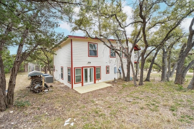 back of house with cooling unit and french doors