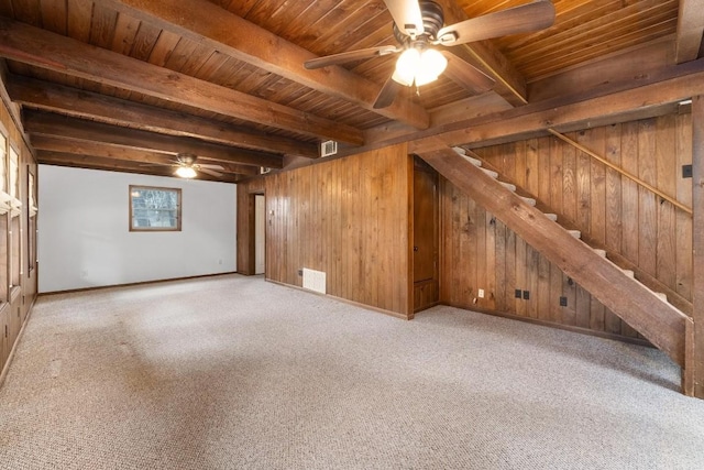 interior space with beamed ceiling, wooden walls, and wood ceiling