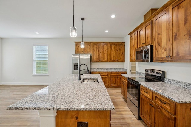 346 Webb St, Smithville, TX 78957 - kitchen featuring brown cabinets, light wood-type flooring, and appliances with stainless steel finishes
