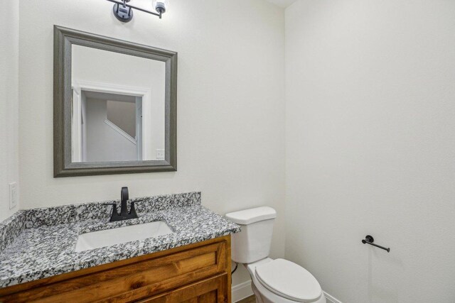 346 Webb St, Smithville, TX 78957 - bathroom featuring baseboards, vanity, and toilet