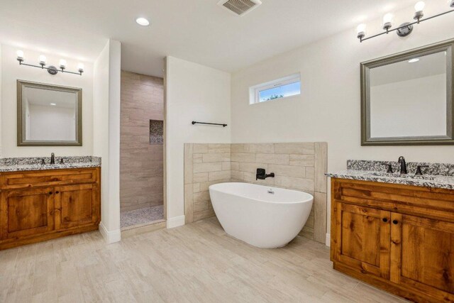 346 Webb St, Smithville, TX 78957 - bathroom featuring two vanities, visible vents, a sink, and a walk in shower