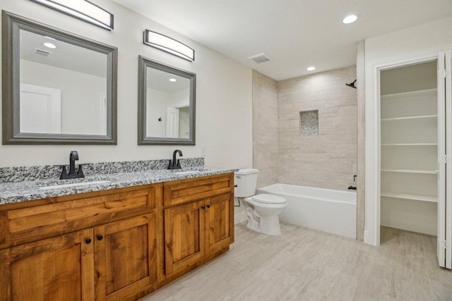346 Webb St, Smithville, TX 78957 - bathroom featuring wood finished floors, visible vents, and a sink
