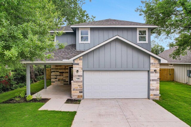 346 Webb St, Smithville, TX 78957 - view of front of house featuring a front lawn, stone siding, fence, concrete driveway, and a shingled roof