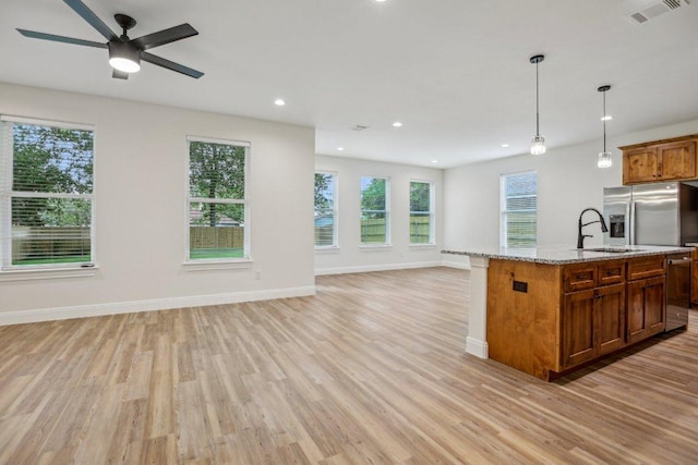 346 Webb St, Smithville, TX 78957 - kitchen with open floor plan, a sink, visible vents, and light wood-type flooring