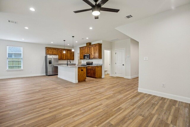 346 Webb St, Smithville, TX 78957 - kitchen with light wood-type flooring, visible vents, open floor plan, and stainless steel appliances