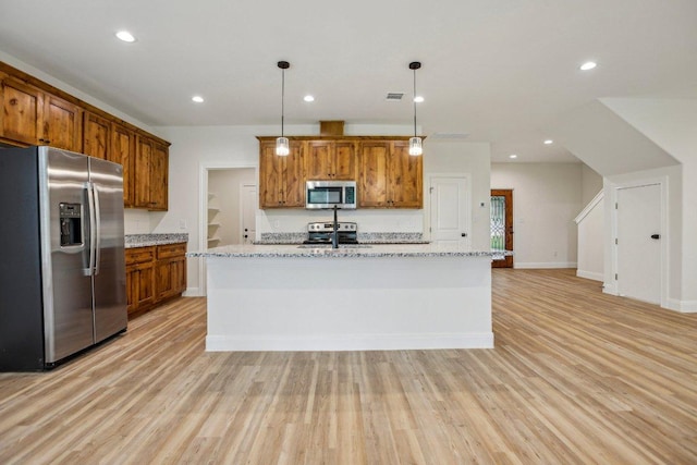 346 Webb St, Smithville, TX 78957 - kitchen with brown cabinetry, light wood-style flooring, and appliances with stainless steel finishes