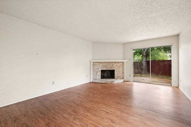 unfurnished living room featuring a textured ceiling and light hardwood / wood-style flooring