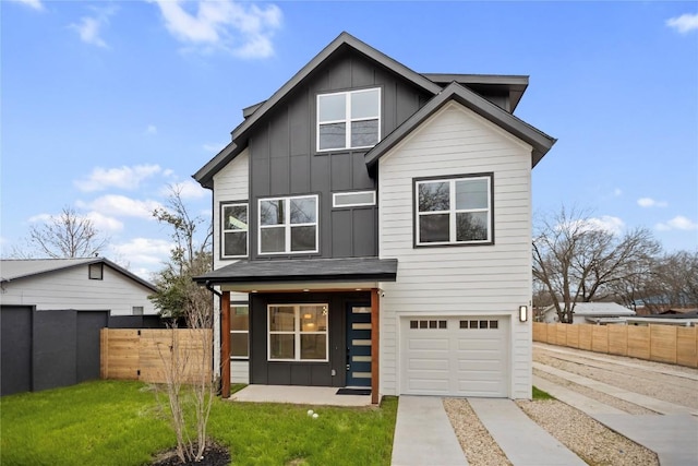 view of front of house with a garage, a porch, and a front yard