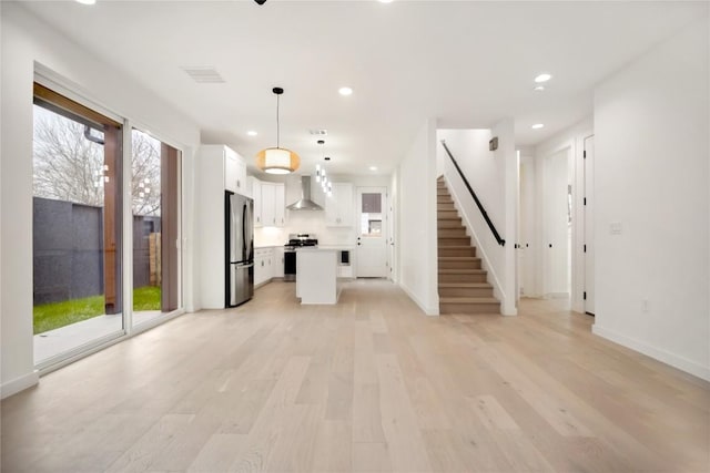 unfurnished living room with light hardwood / wood-style floors