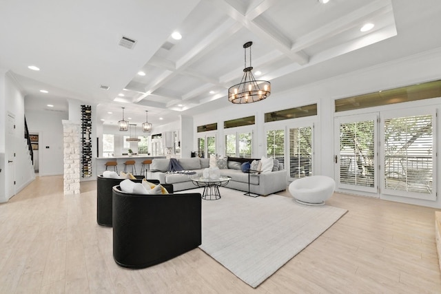 living room with light wood-type flooring, visible vents, coffered ceiling, and a chandelier