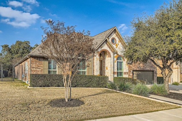 view of front of home with a garage and a front lawn