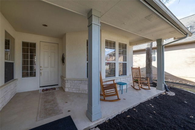 entrance to property featuring covered porch