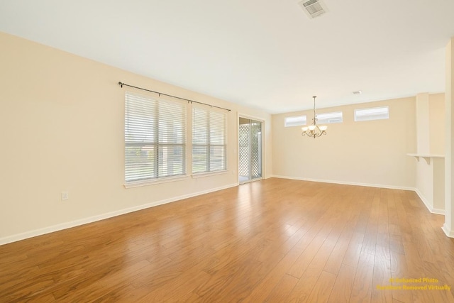 216 Whispering Wind Dr, Georgetown, TX 78633 - unfurnished room with a chandelier and wood finished floors