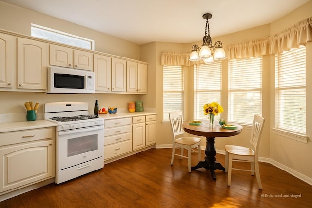 216 Whispering Wind Dr, Georgetown, TX 78633 - kitchen with white appliances, a chandelier, dark wood-style floors, and light countertops