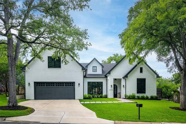 view of front of home featuring a garage and a front yard