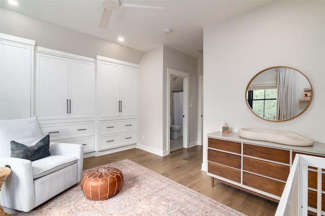 living area featuring ceiling fan and wood-type flooring