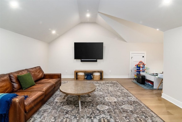 living room with wood-type flooring and lofted ceiling