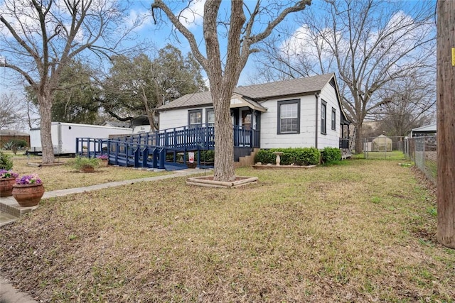 view of front of property featuring a wooden deck and a front yard