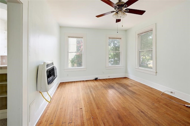 interior space featuring ceiling fan, light hardwood / wood-style floors, and heating unit