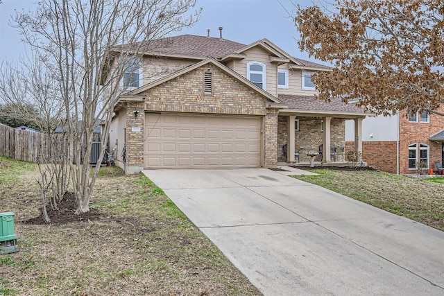 view of property with a garage, a front yard, and a porch