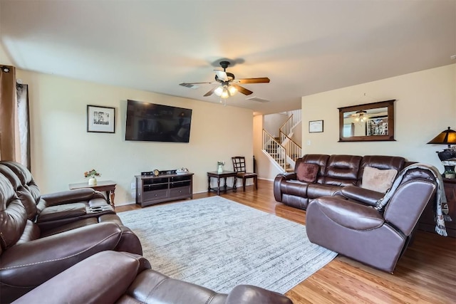 living room featuring light hardwood / wood-style flooring and ceiling fan