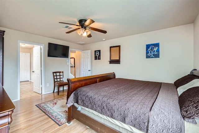 bedroom with light wood-type flooring and ceiling fan