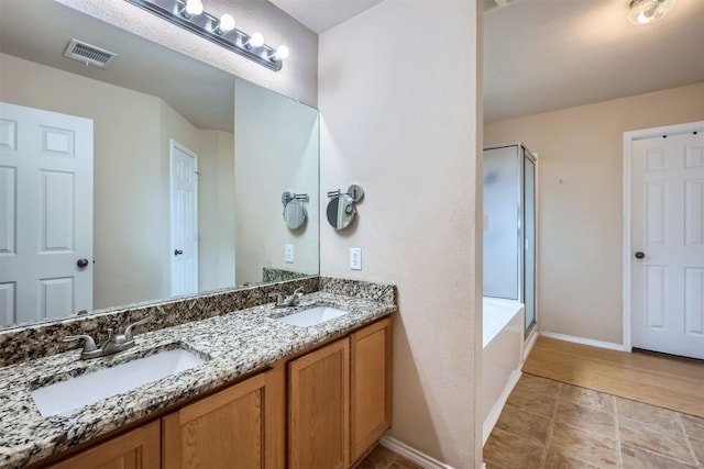 bathroom with separate shower and tub and vanity