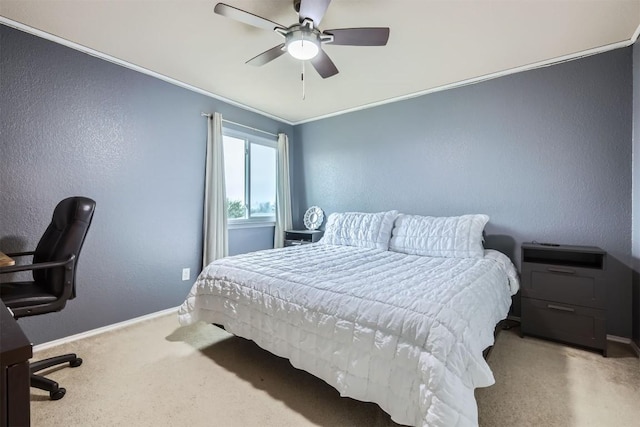 bedroom with ceiling fan, carpet, and crown molding