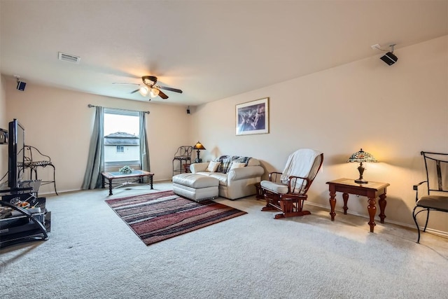 carpeted living room featuring ceiling fan