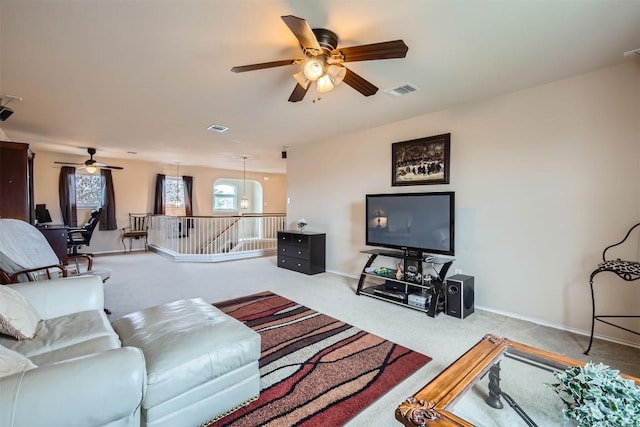 carpeted living room featuring ceiling fan