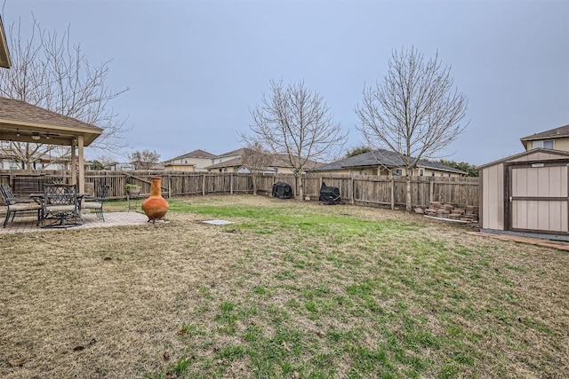 view of yard featuring a patio and a storage shed