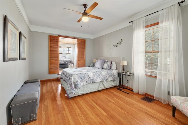 bedroom with ceiling fan and light hardwood / wood-style floors