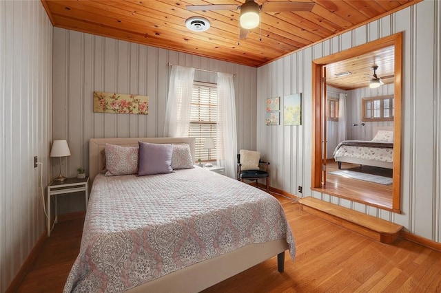 bedroom with hardwood / wood-style floors and wood ceiling