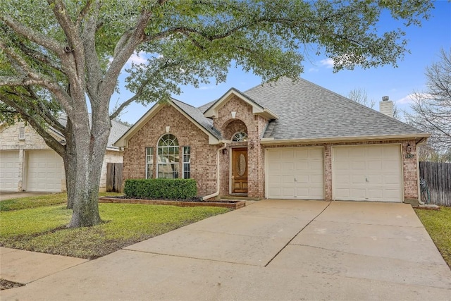 single story home with a garage and a front lawn