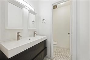 bathroom with toilet and vanity