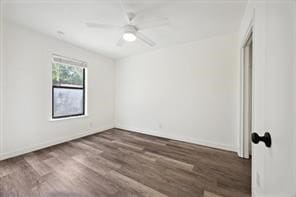 unfurnished room with ceiling fan and dark wood-type flooring